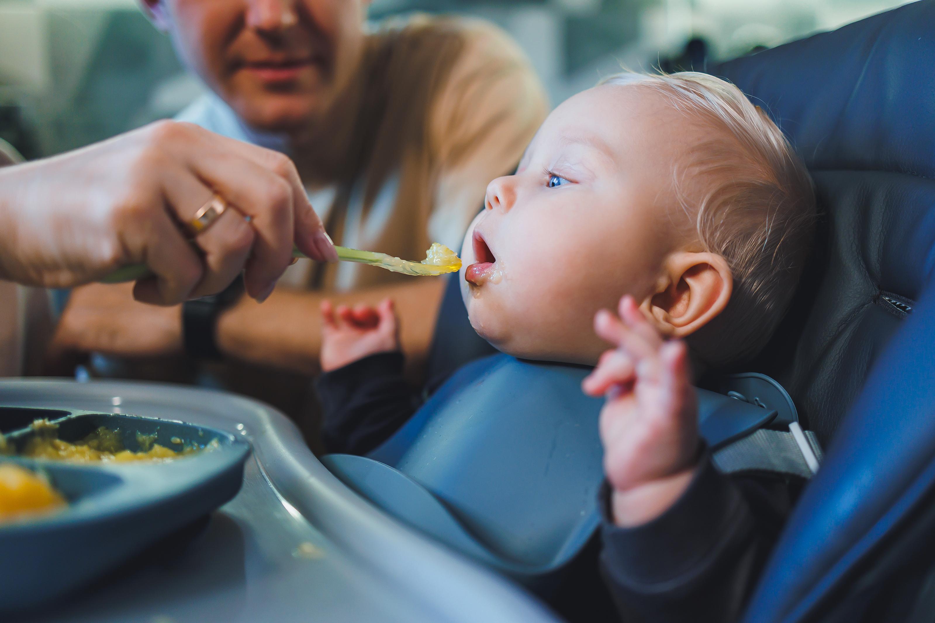 A person feeding a baby