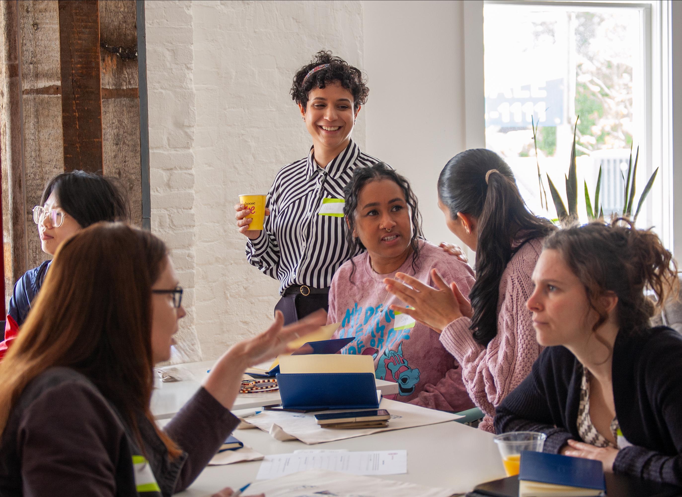 women talking around a table