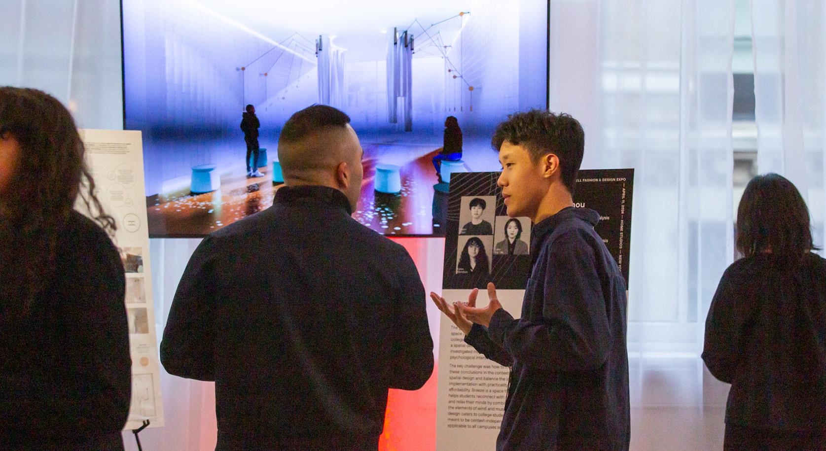 A student explaining a poster