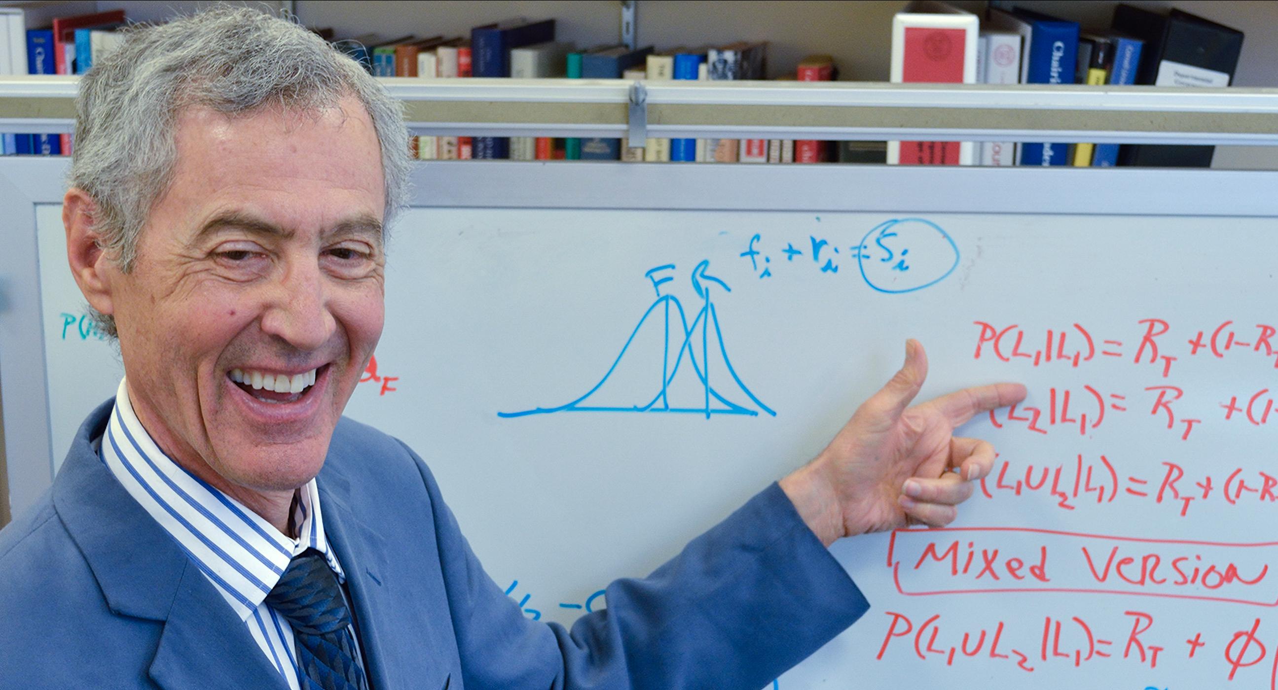 professor pointing at a whiteboard