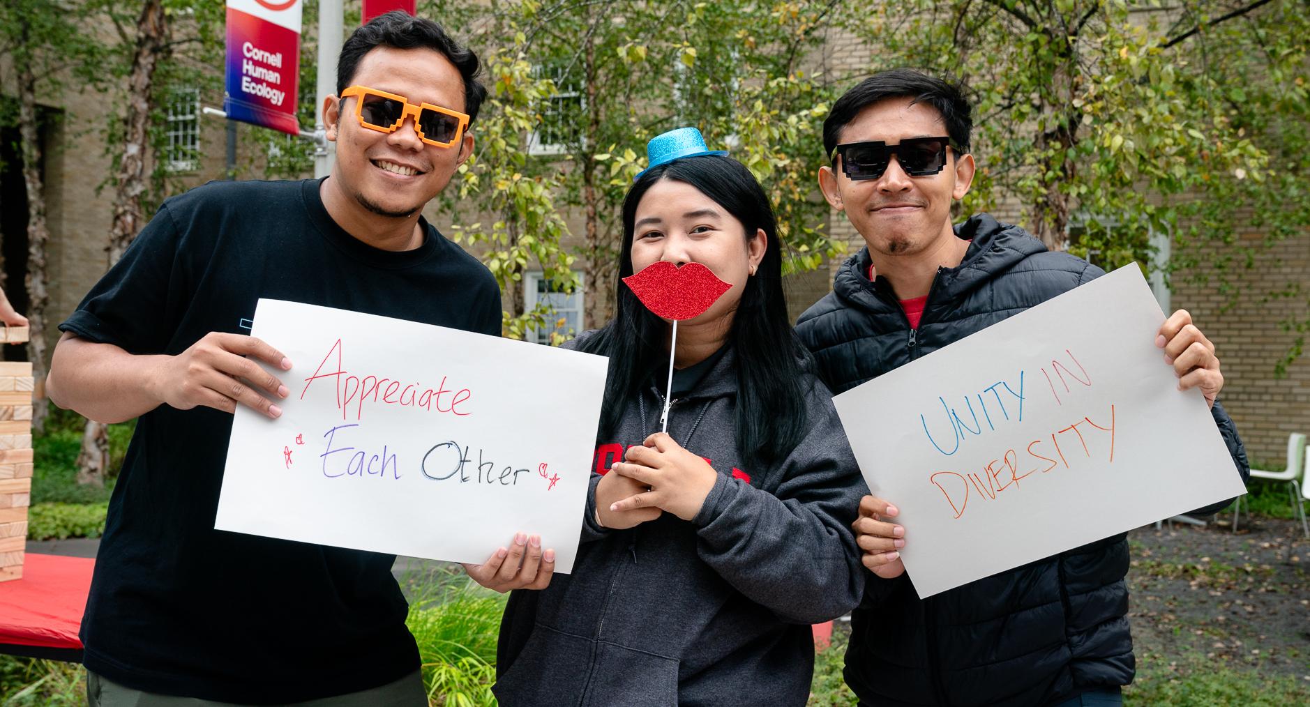 college students posing with signs saying "Appreciate Each Other" and "Unity in Diversity"
