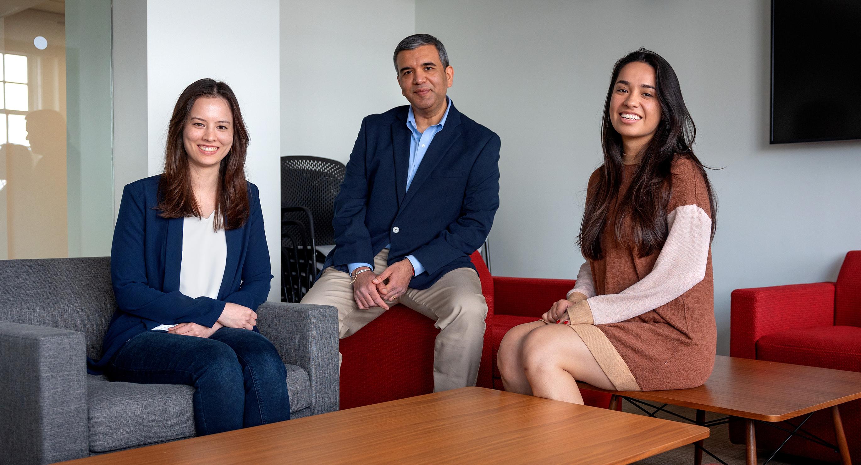 three people sitting on and looking at the camera