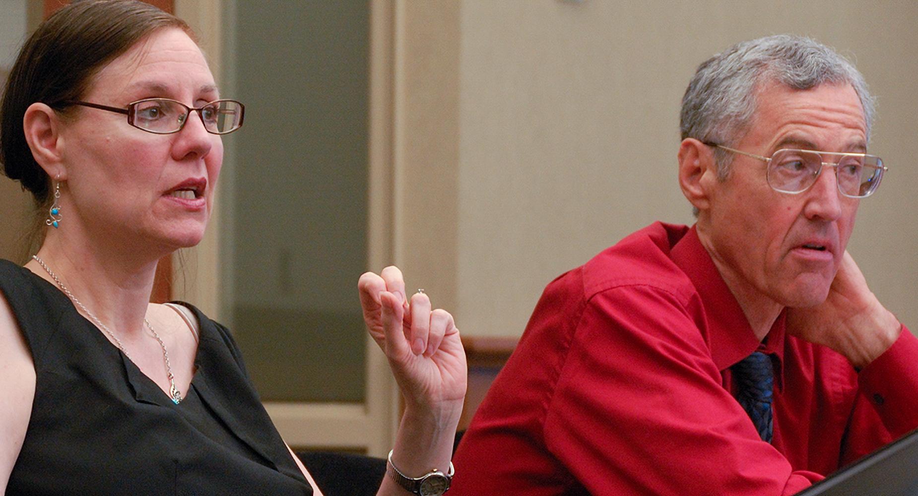 two professors sitting at a conference table