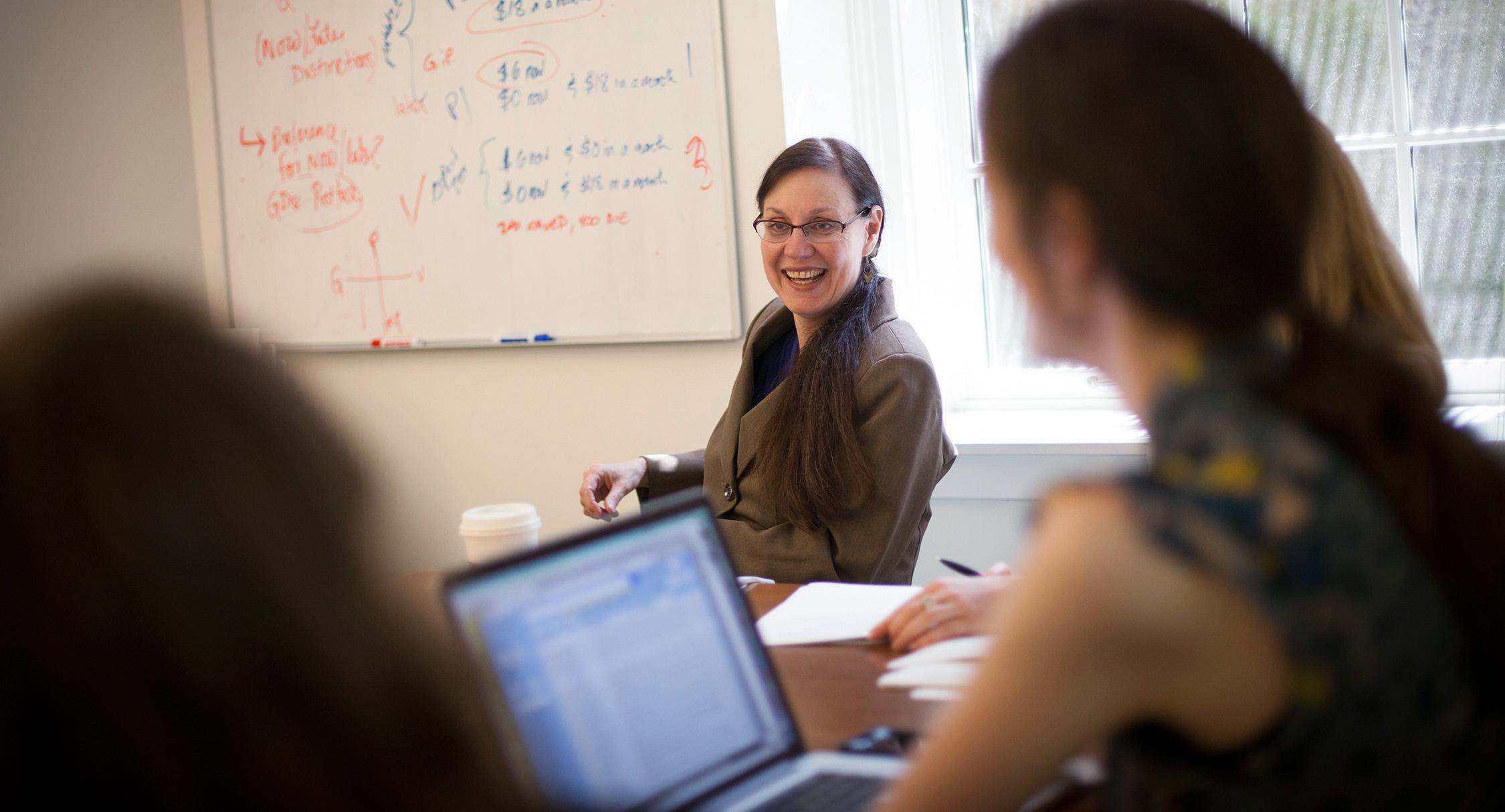professor smiling in a meeting
