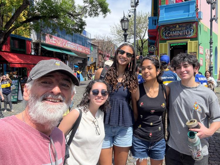 Katrina and friends pose on a busy city street in South America