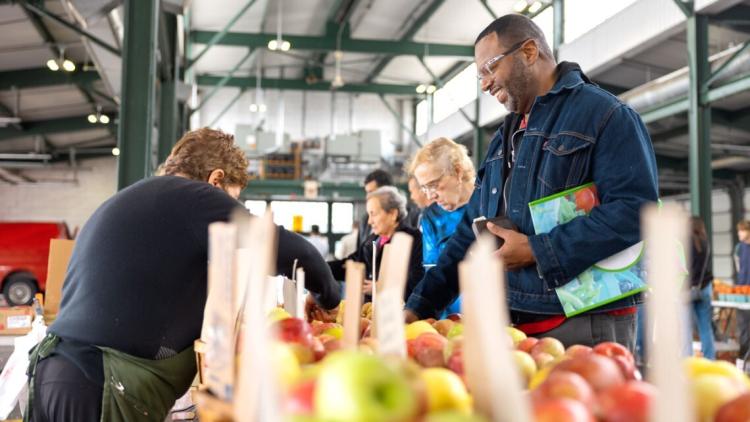 Person receiving apples at a food pantry 