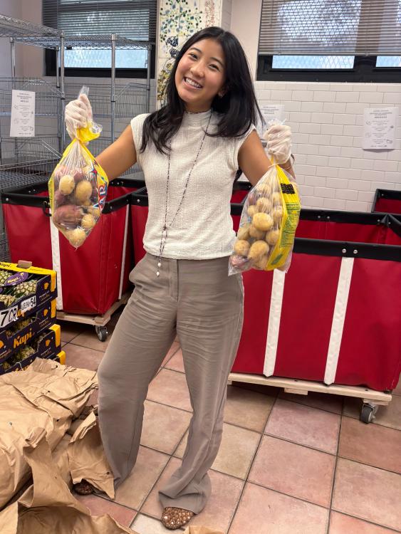 Madeline Lee holding a sack of potatoes
