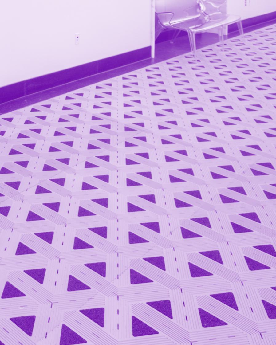 purple tinted image of a stairway railing and a patterned tile floor