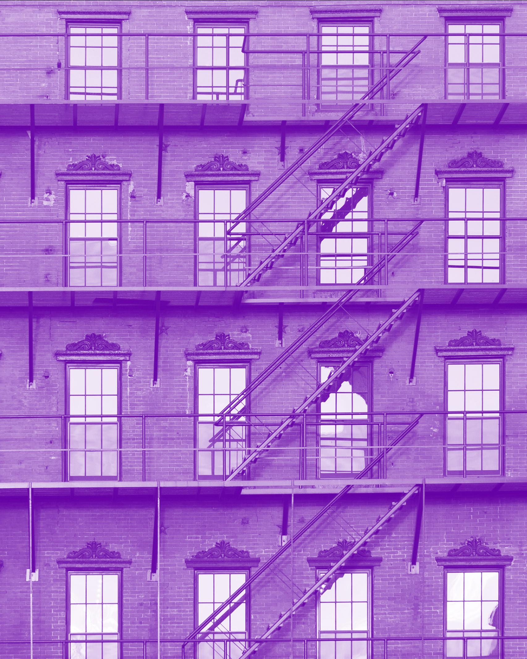 purple tinted image of the facade of a brick building