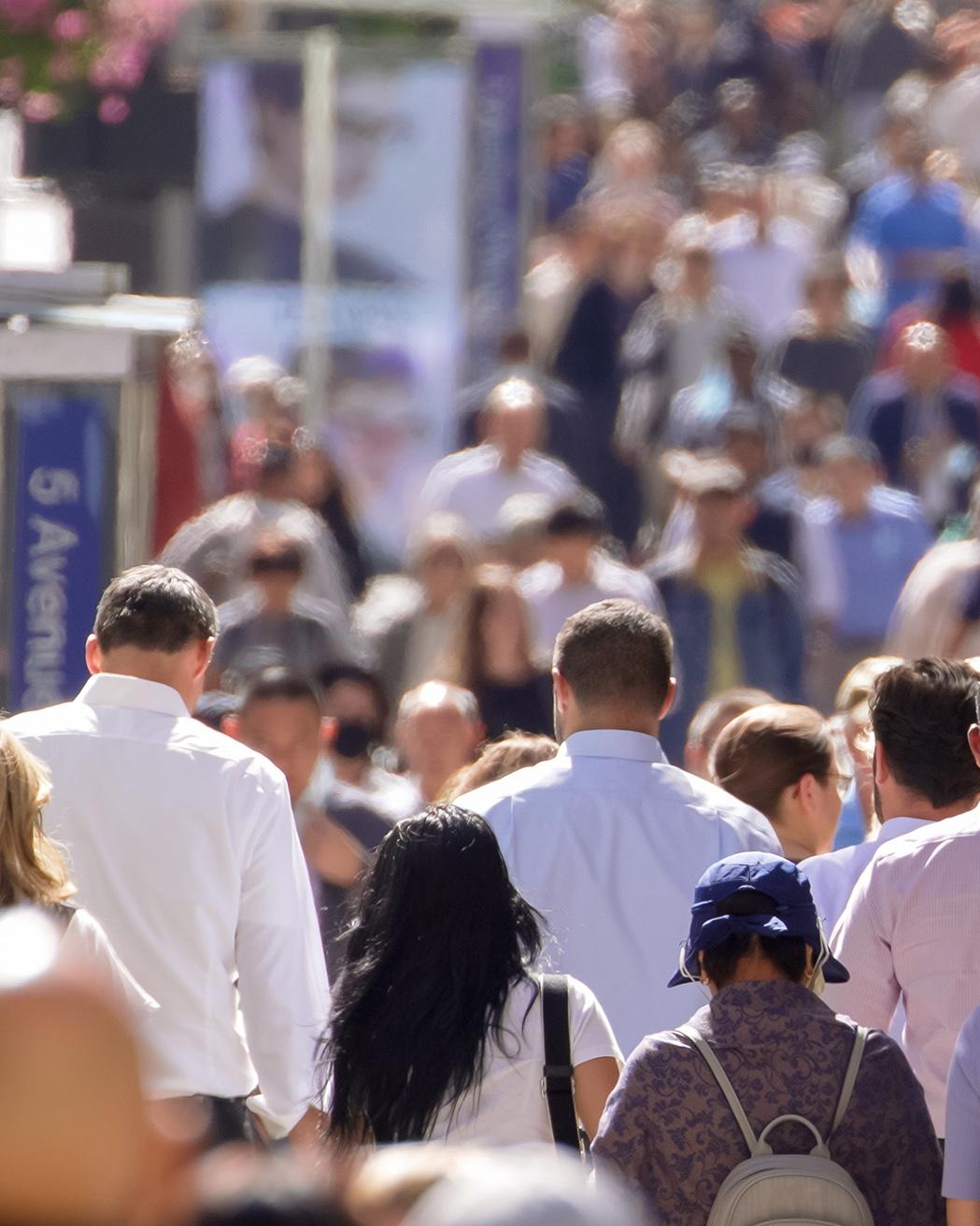 crowd of people on a city sidewalk