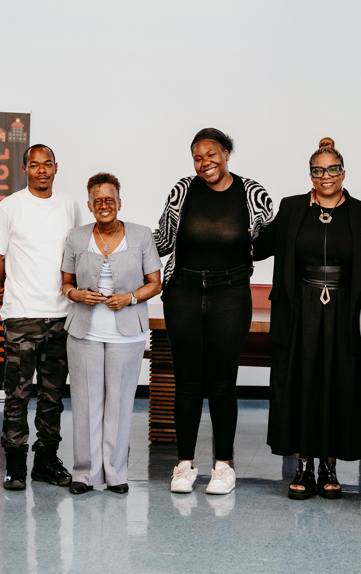 group of eight people standing in a line posing and smiling for the camera
