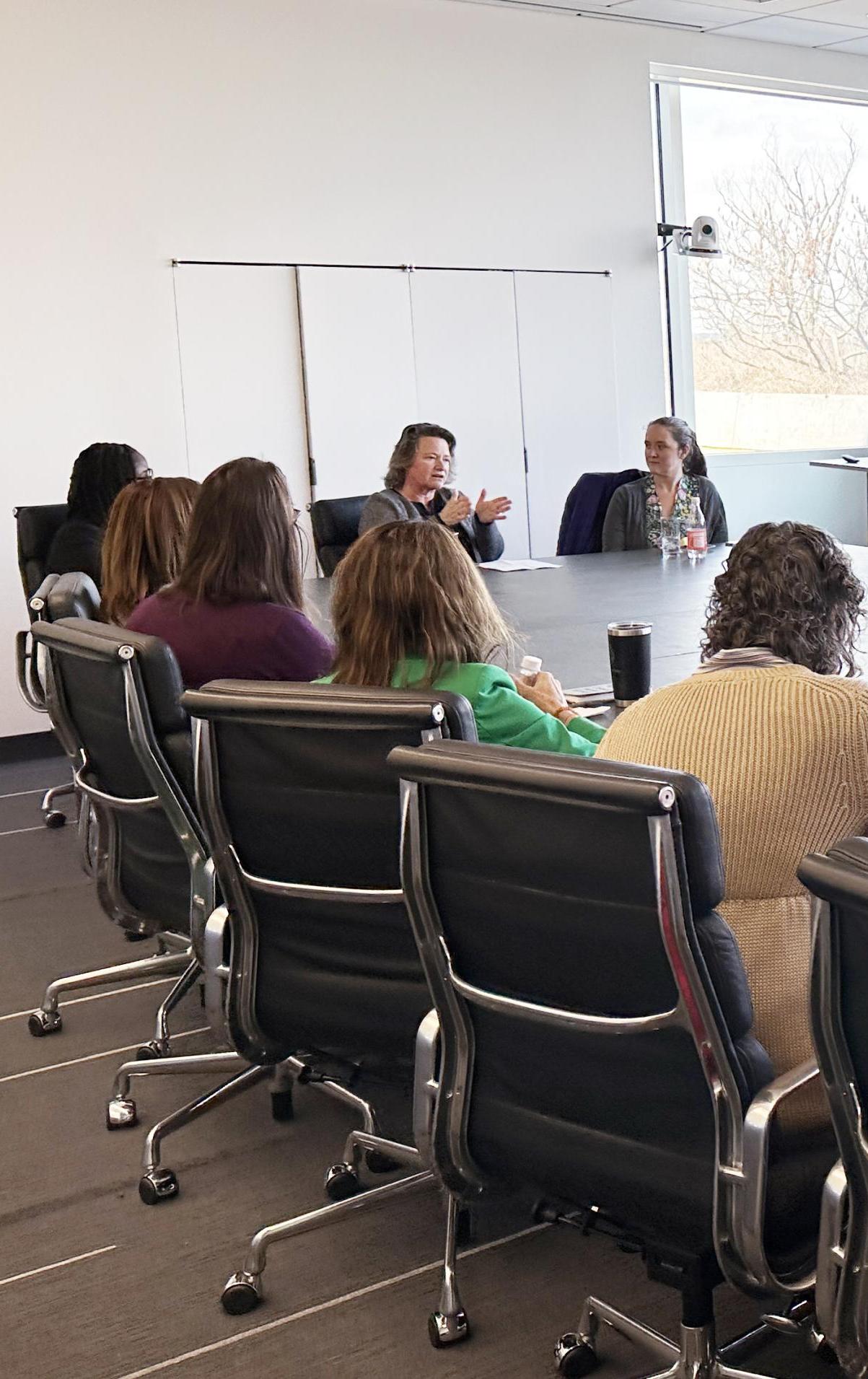people sitting at a table in a bright conference room