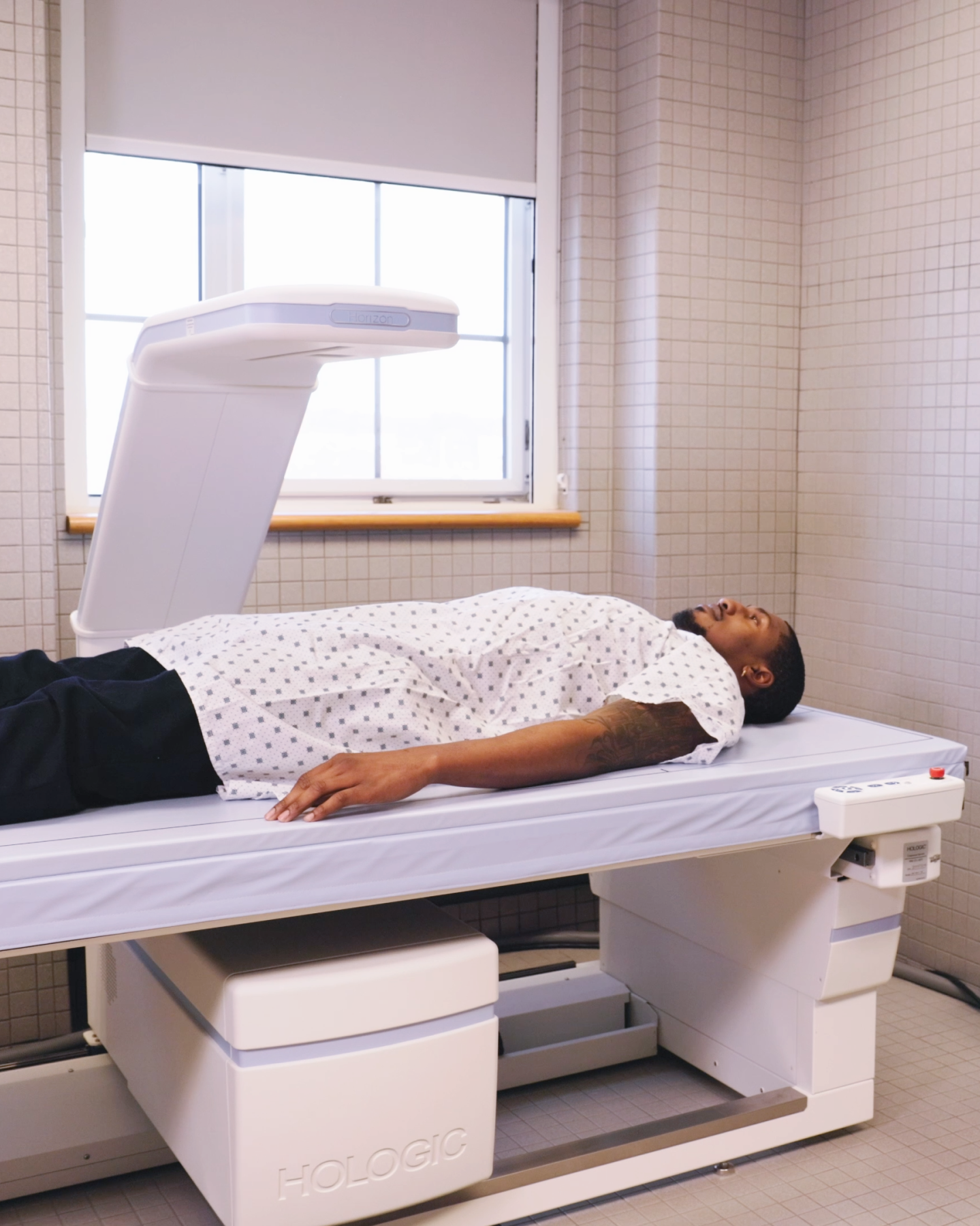 man lying on a dexascanner in a lab