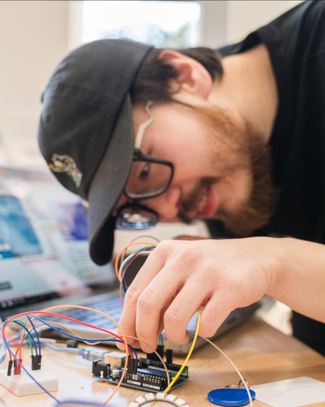graduate student looking at some wiring
