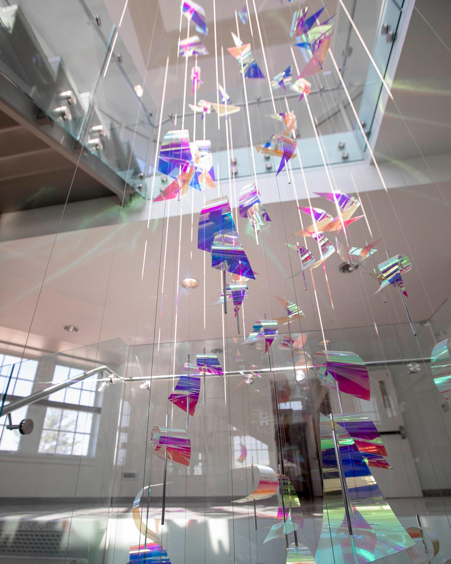 iridescent mobile hanging in an open stairway