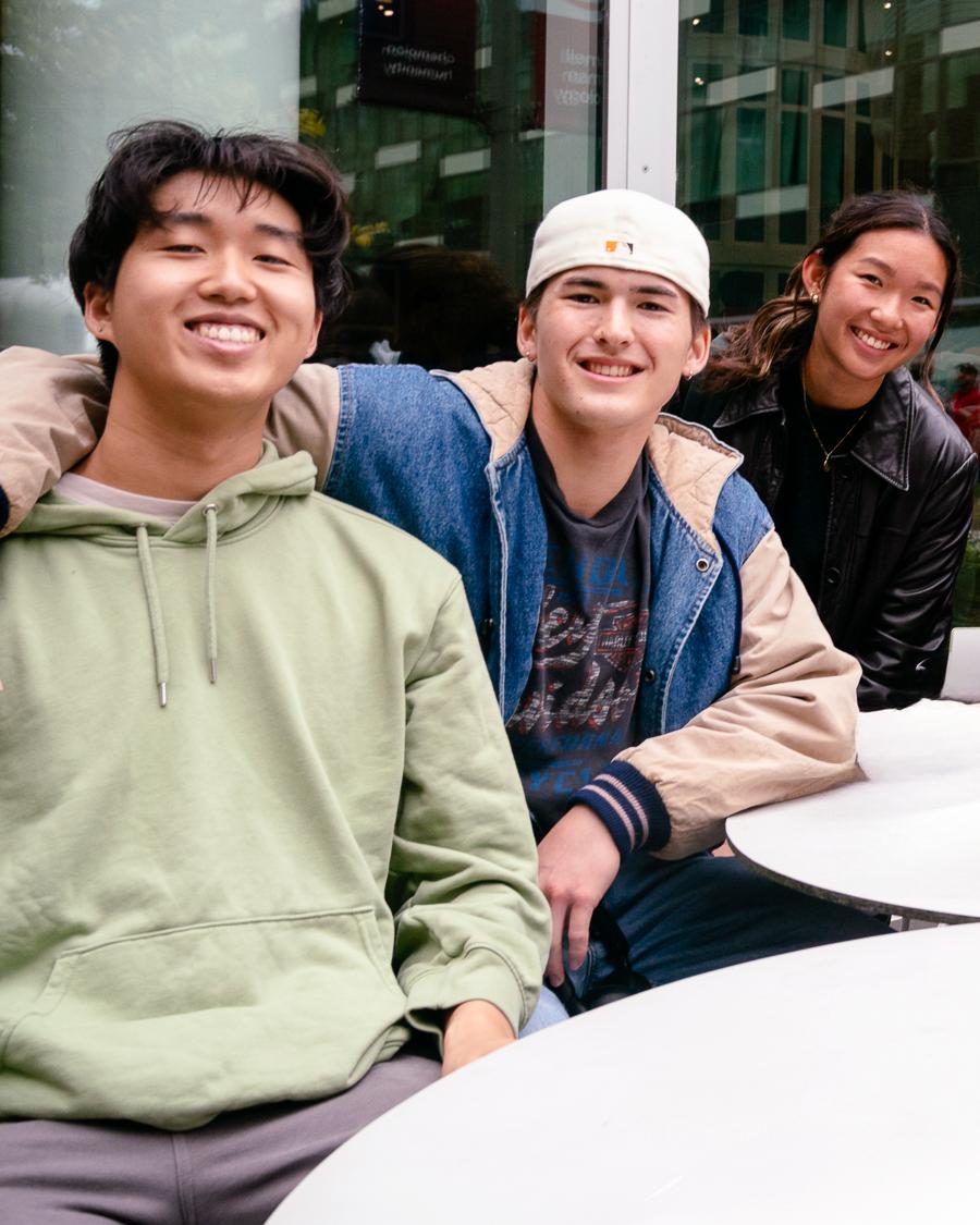 college students posing while sitting at an outdoor table