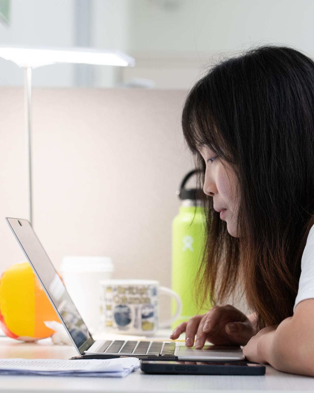 college student working on a laptop