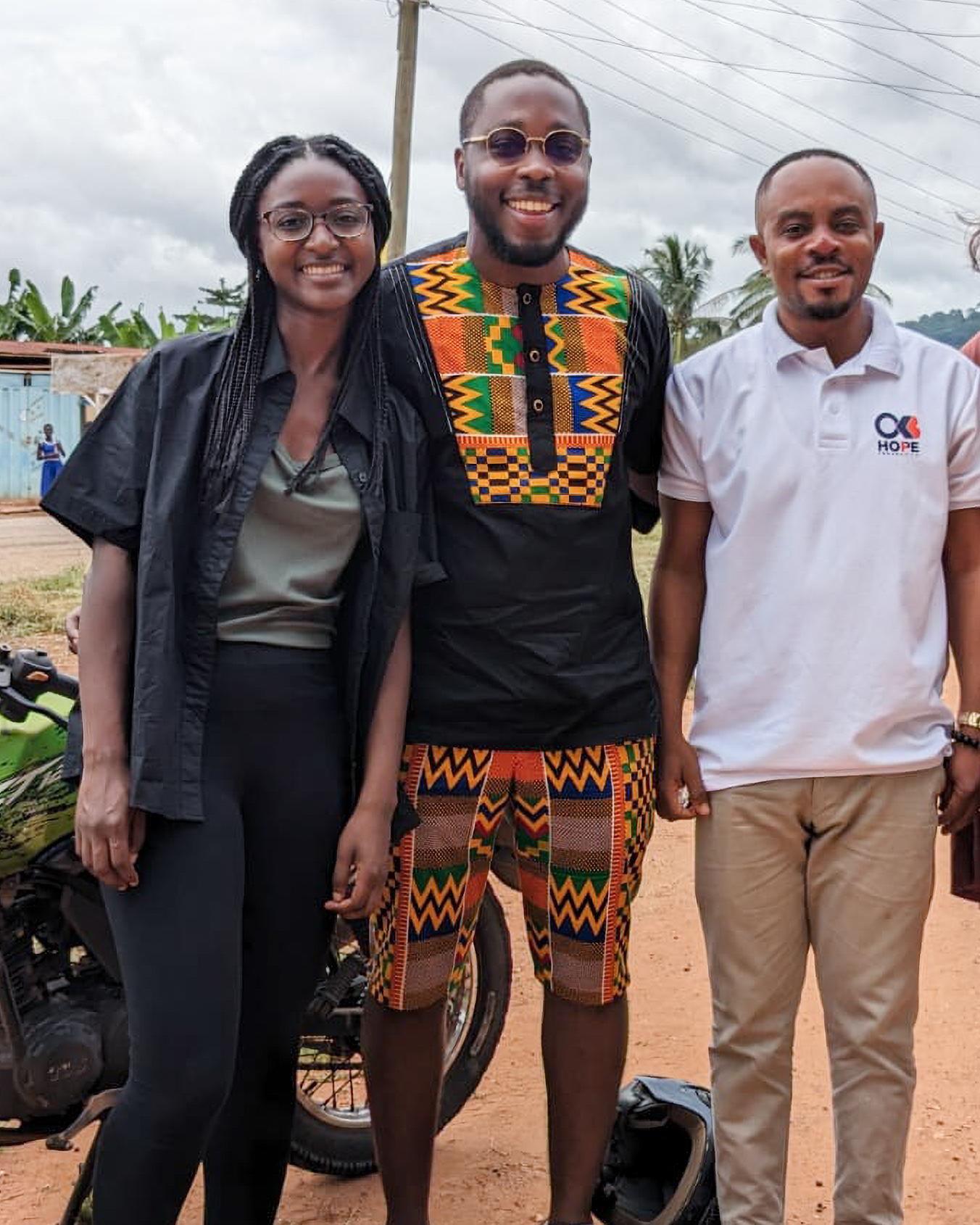 people standing outside next to a motorbike in Ghana