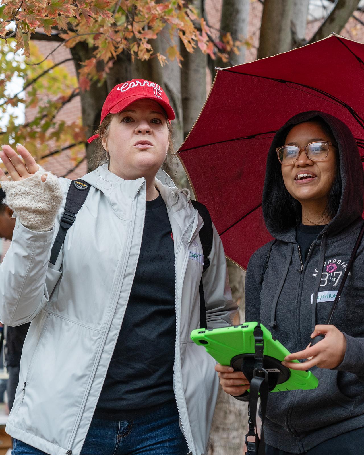 professor and student stand talking in a playground