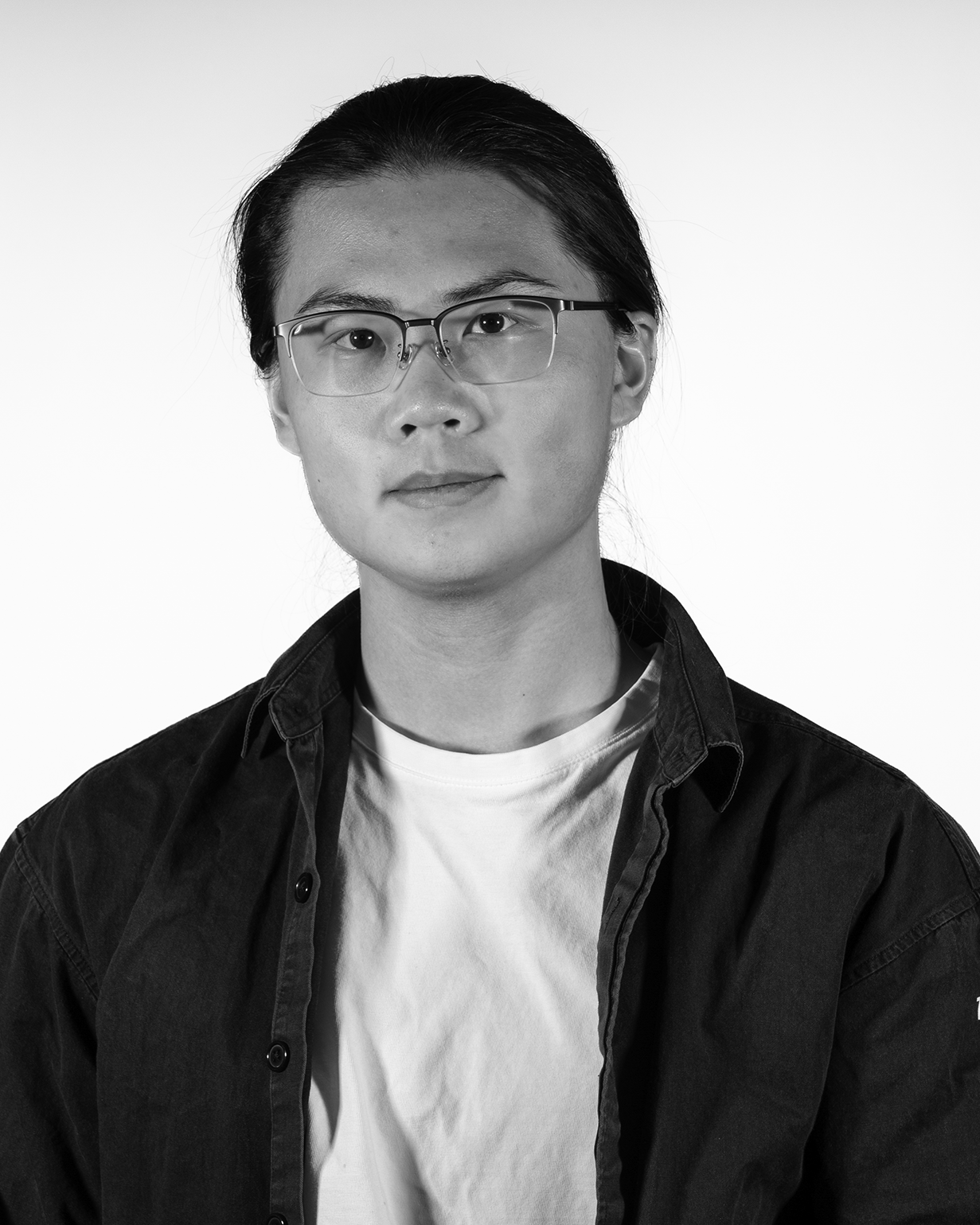 portrait of a person with glasses wearing a dark jacket