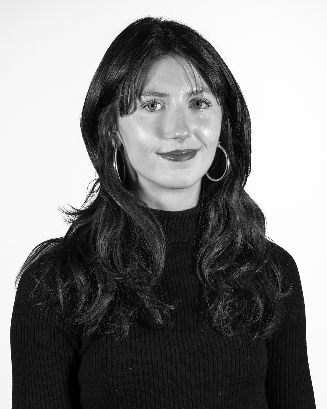 person with long hair in a black shirt