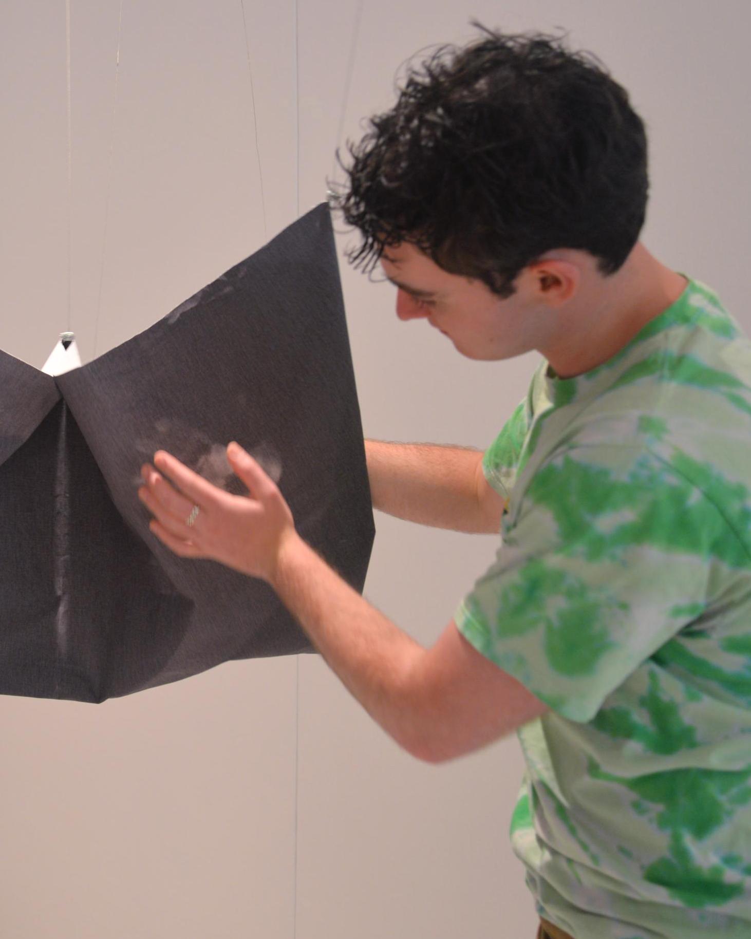 A student demonstrates how the thermochromic fabric works