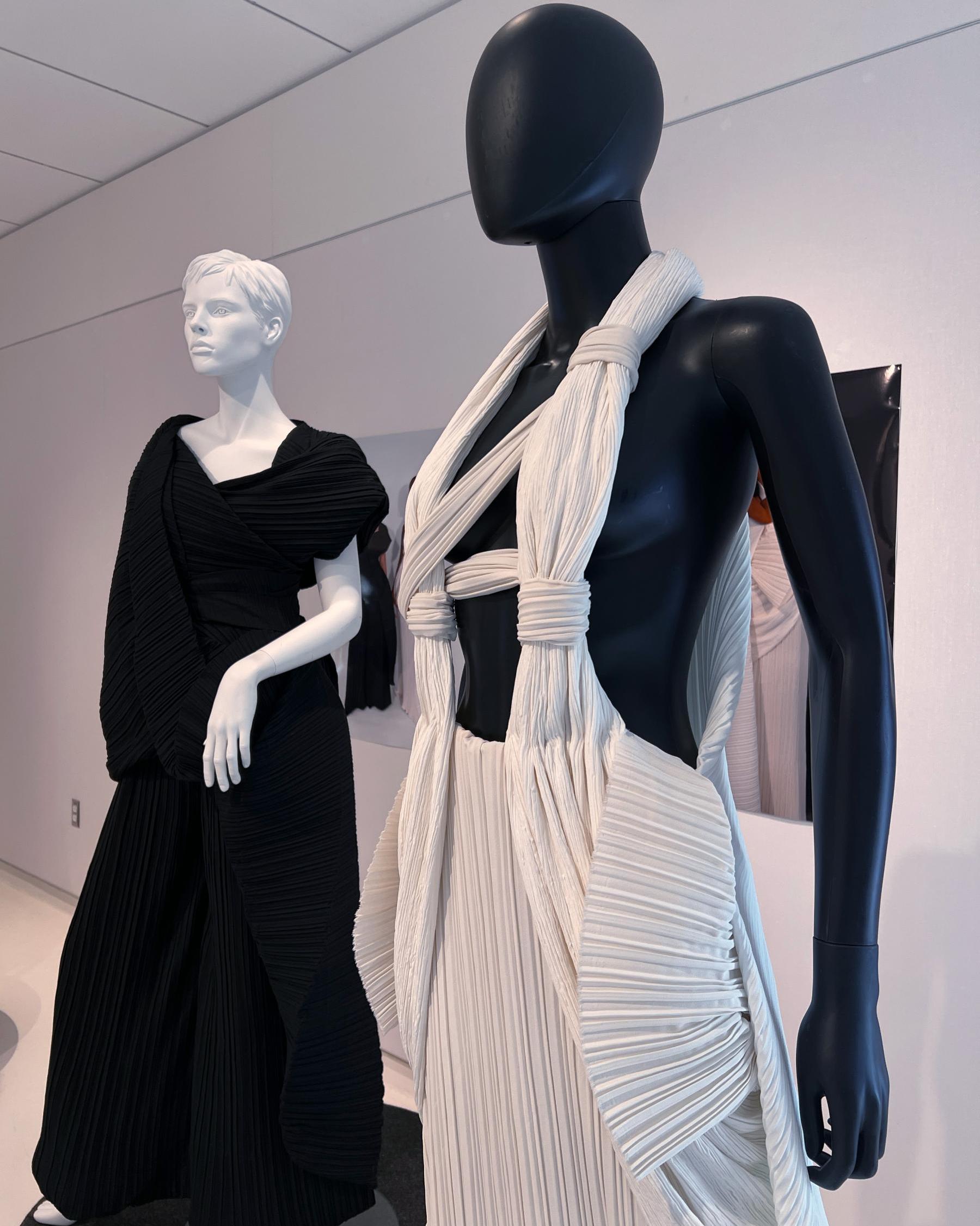 Two pleated zero waste gaments one in black and one in white