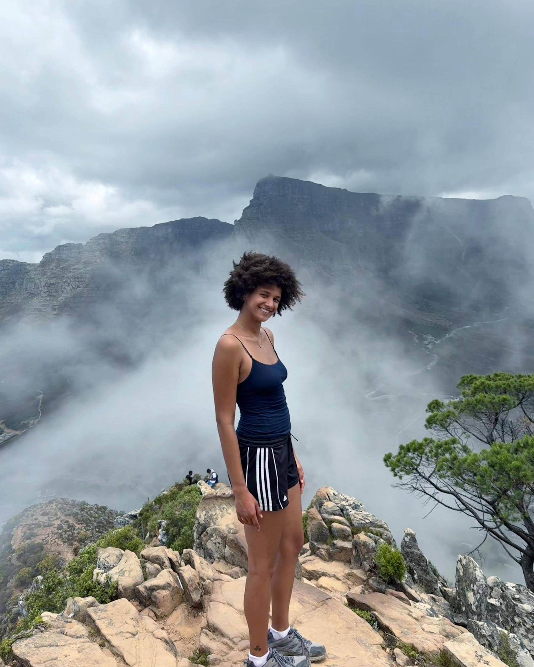 Katrina Samuda '26 stands atop of a foggy mountain top