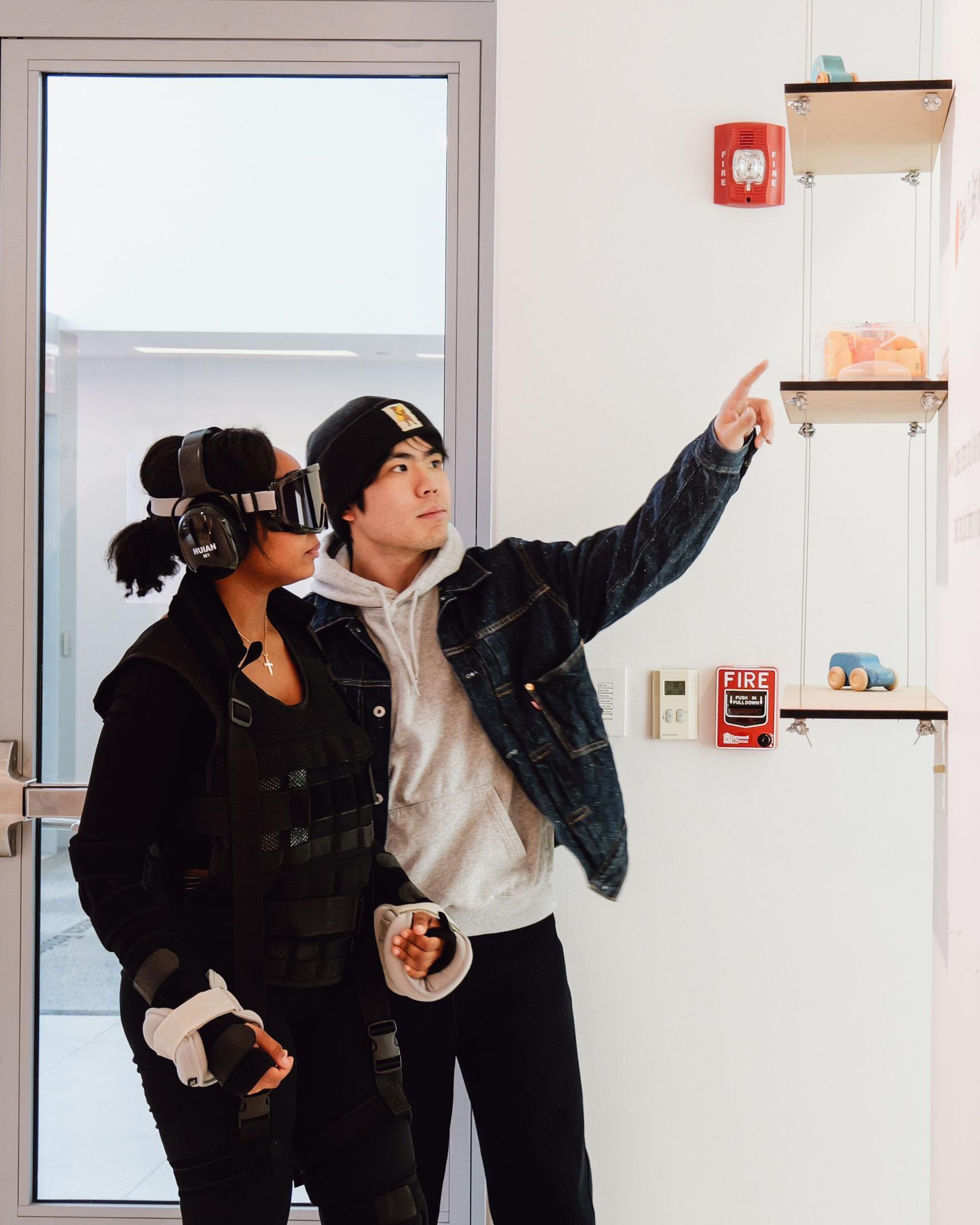 Ruizeng Wang helping a participant in an aging exhibit