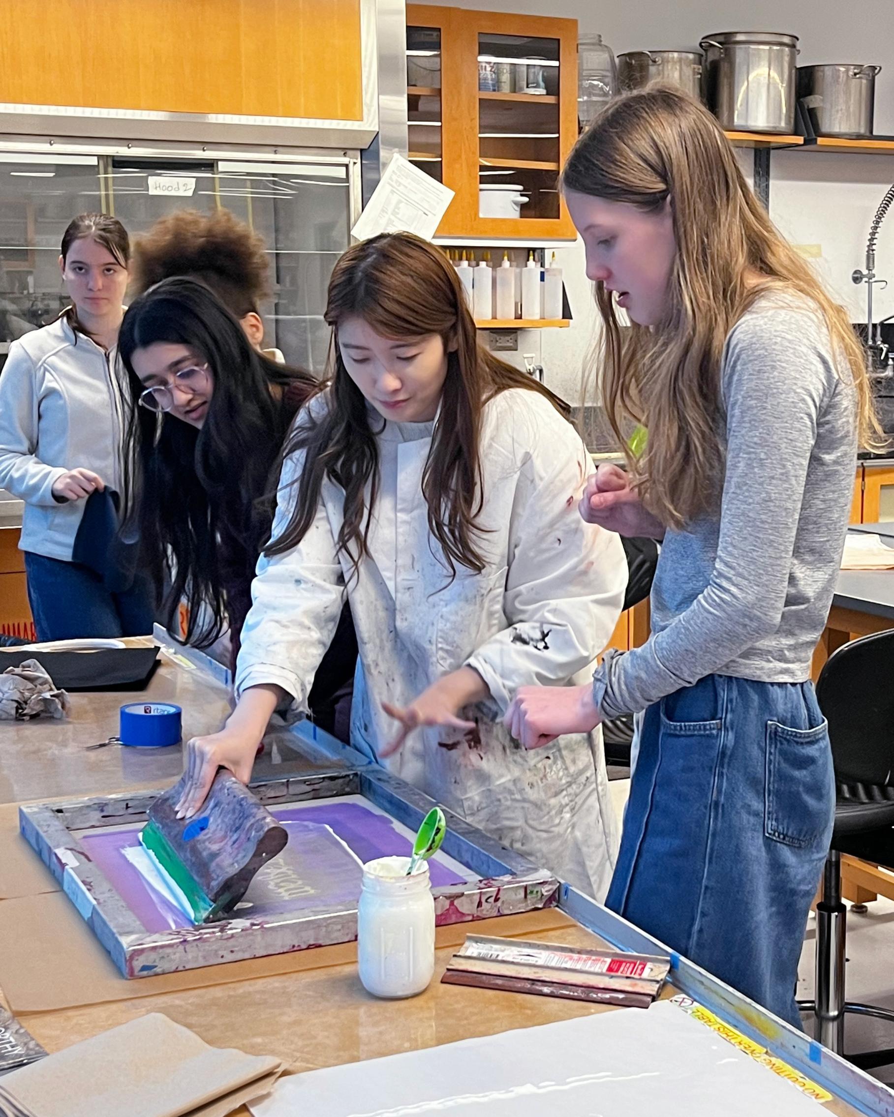 Students work on screen printing We The People