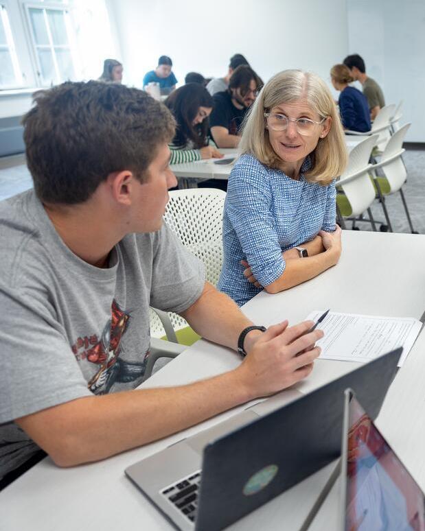 A student talks with a professor