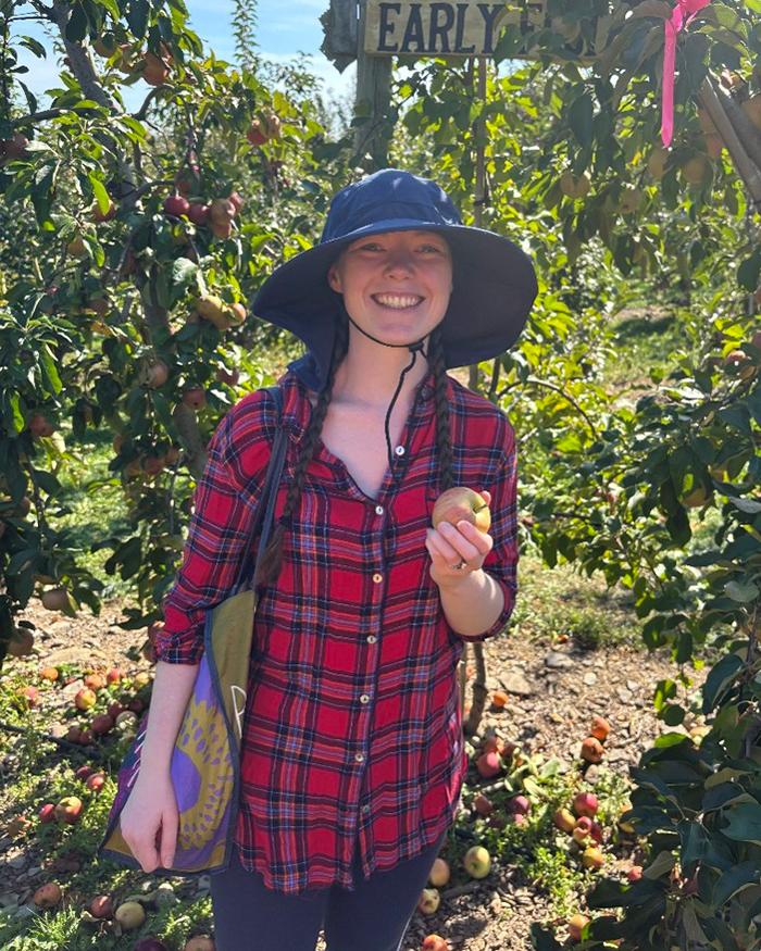 Paige Cunningham smiling at an apple orchard