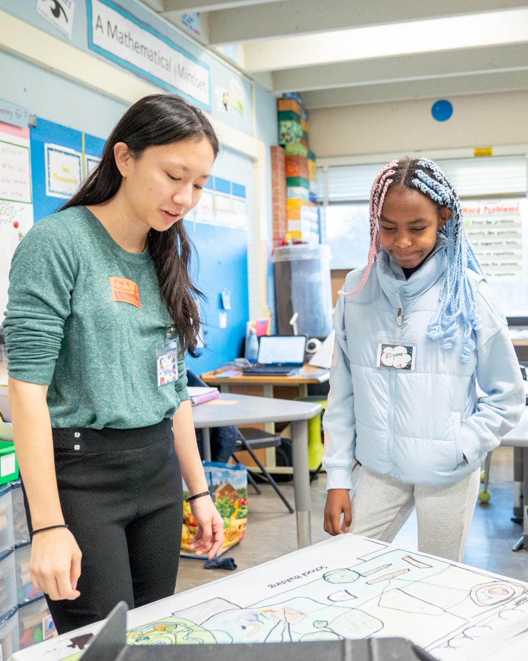 Ashley looks at plans with a student 