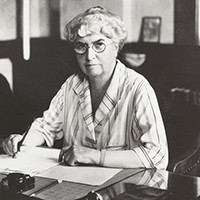 woman at a desk writing