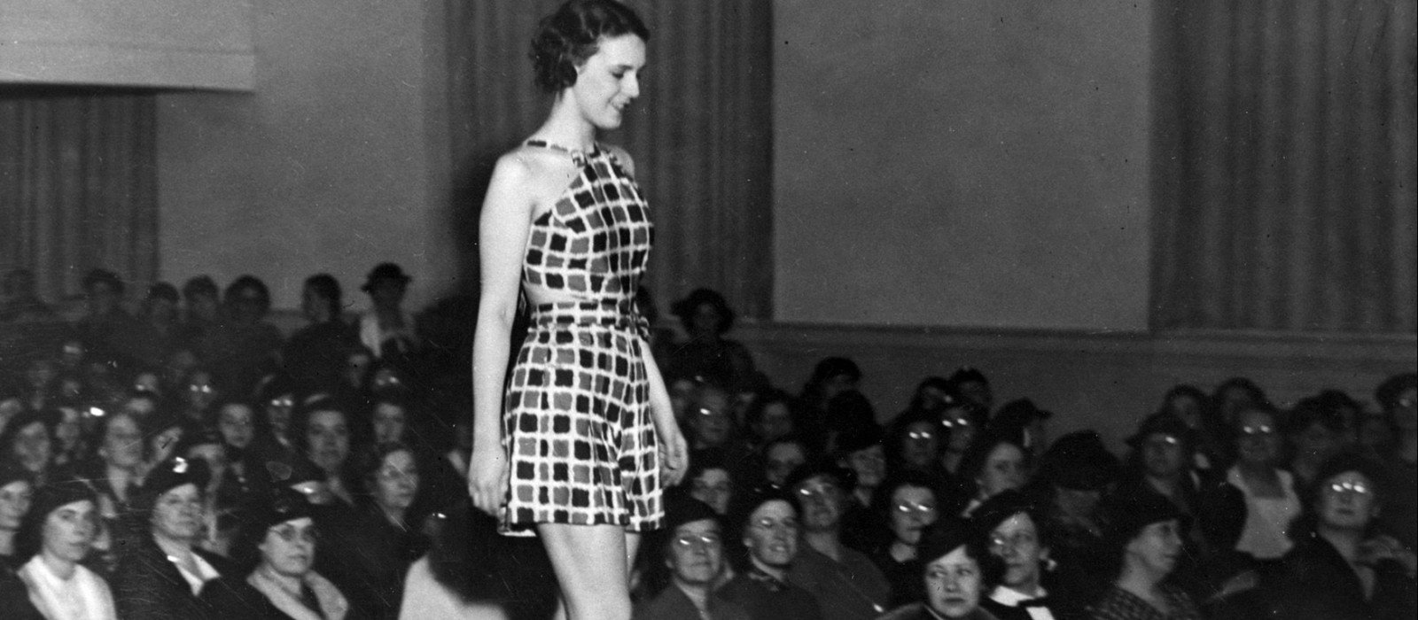 Woman in a swim suit walking a runway on Cornell campus in 1940