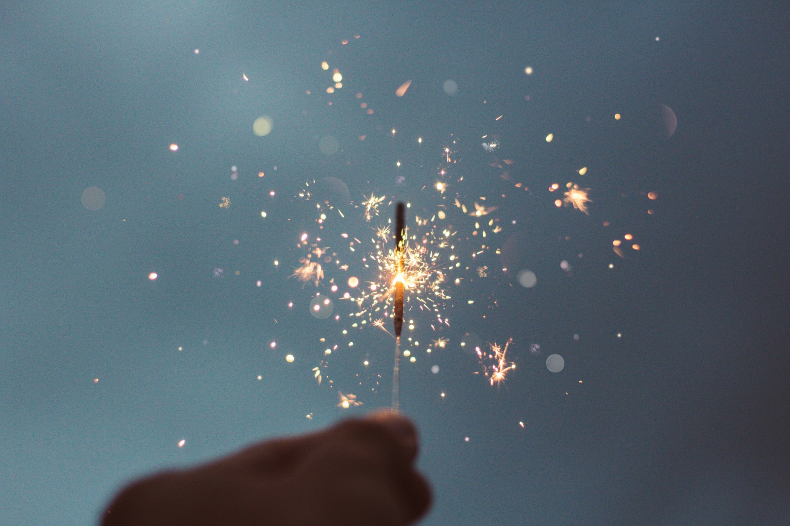 hand holidng a lit sparkler