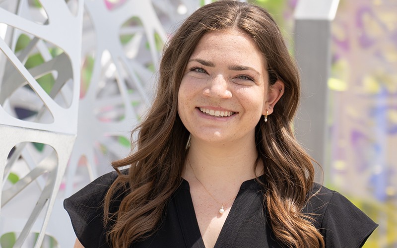 Rebecca Gordon wearing a black blouse and smiling outside.