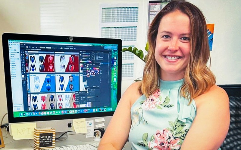 Jeanne Douglass Diaz ’10 sits at her desk in the offices of GK Elite Sportswear.