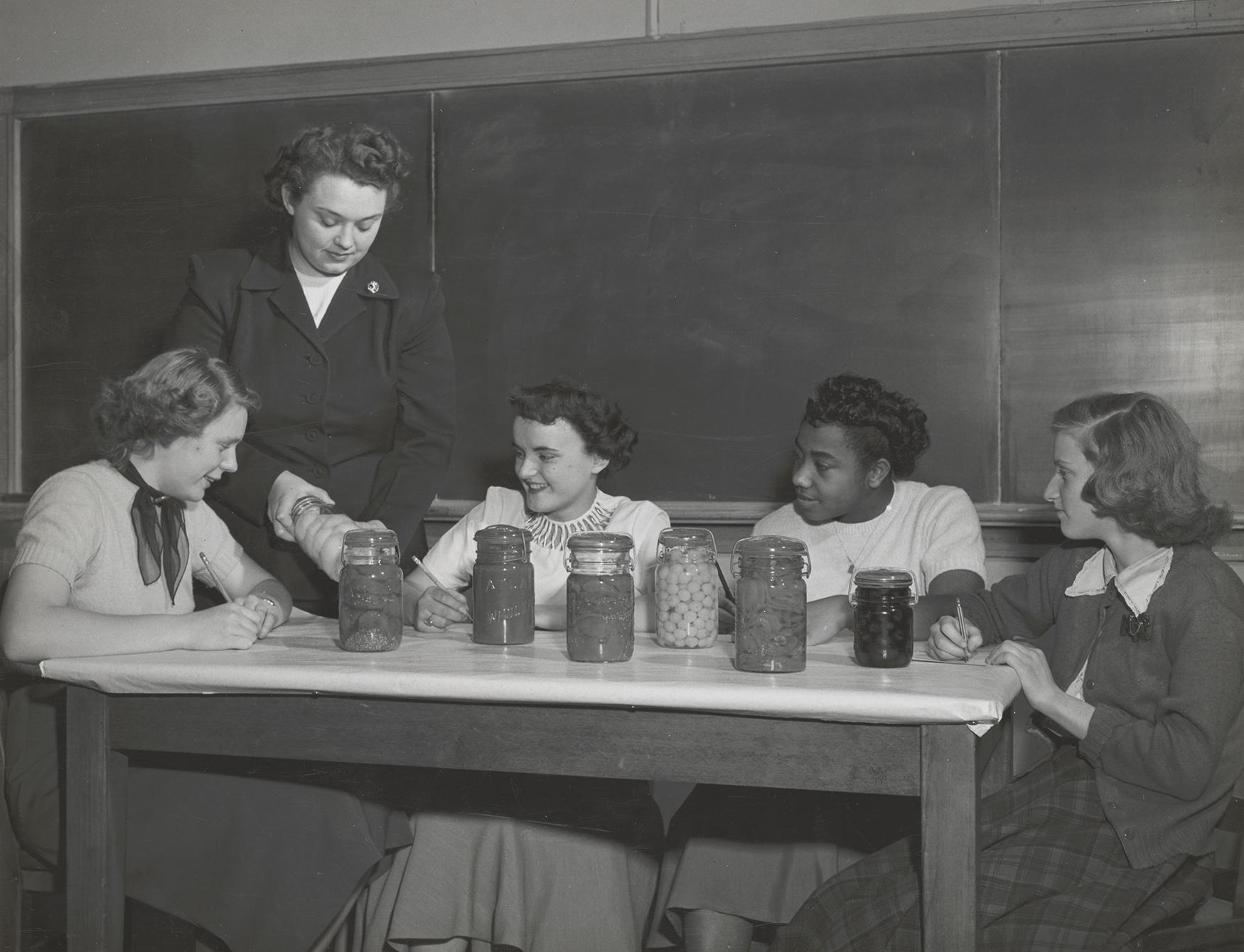 Women watching a canning demonstration in the 1940s