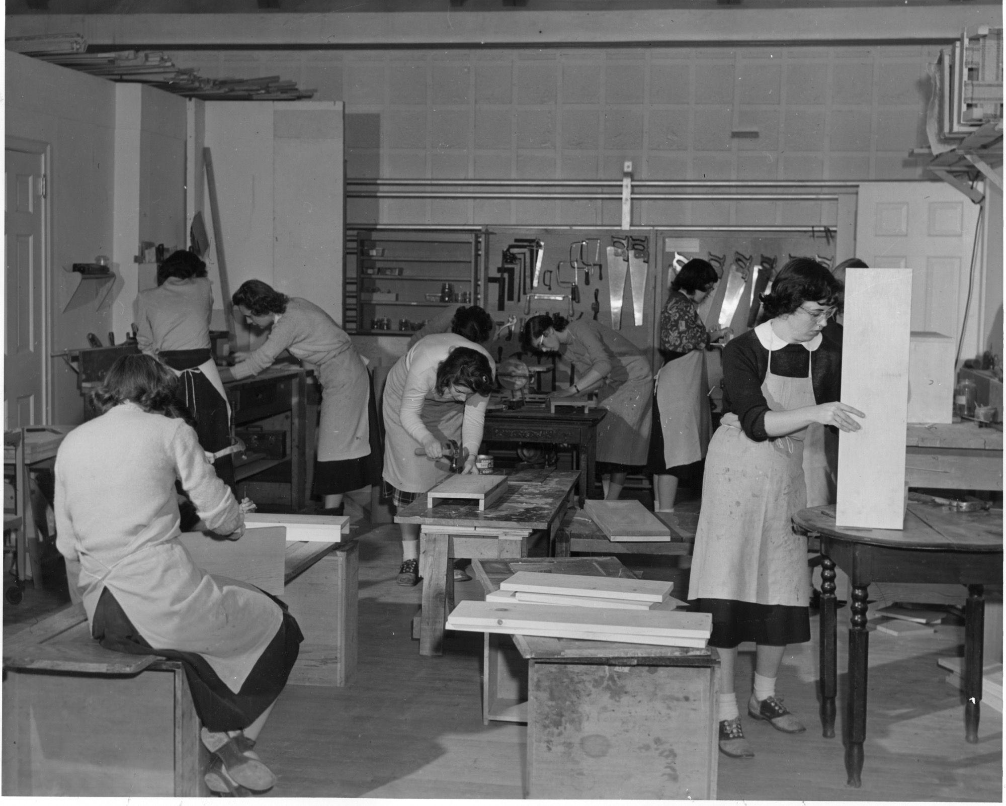 A class works in a woodworking shop