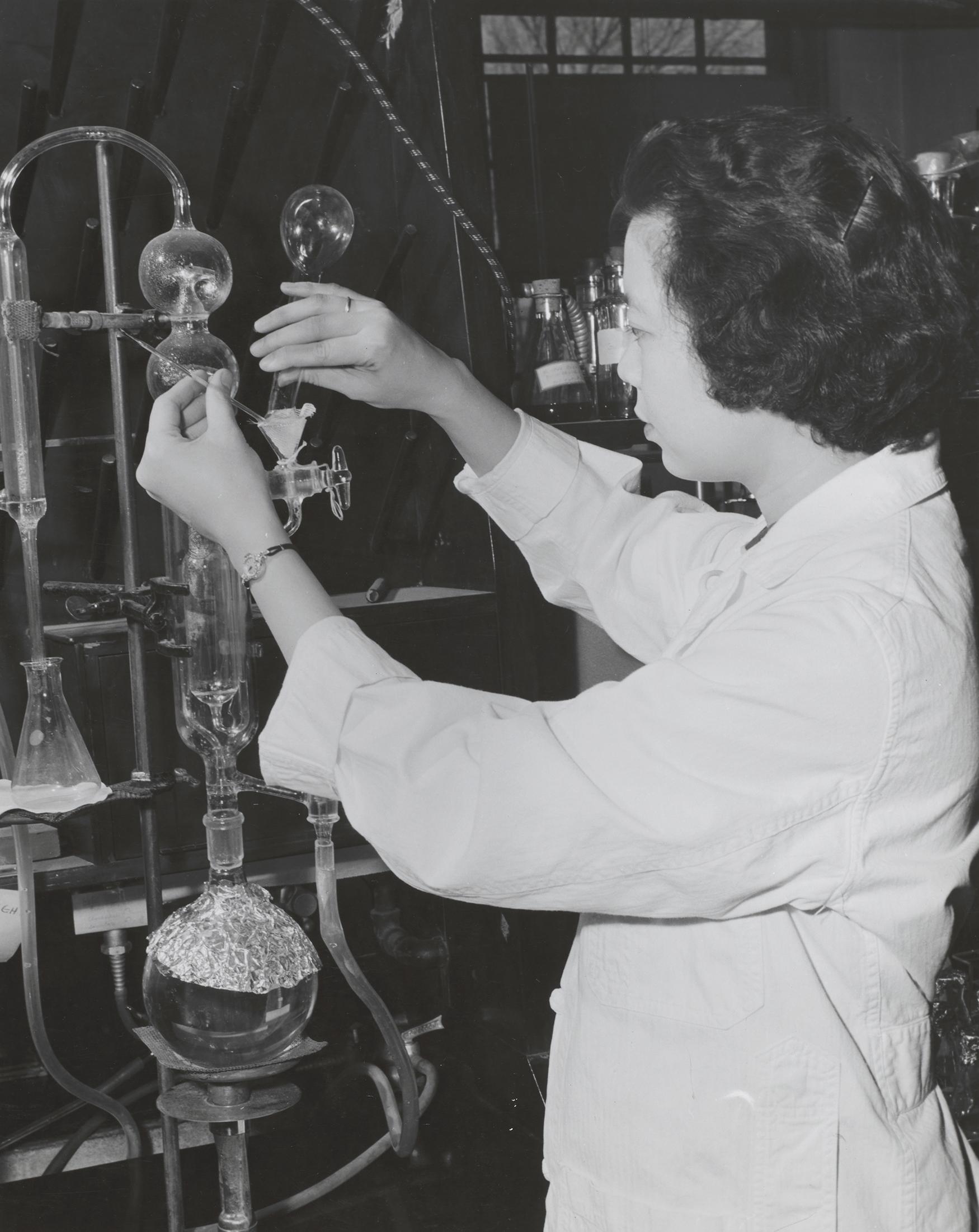 woman in a lab coat working with lab equipment