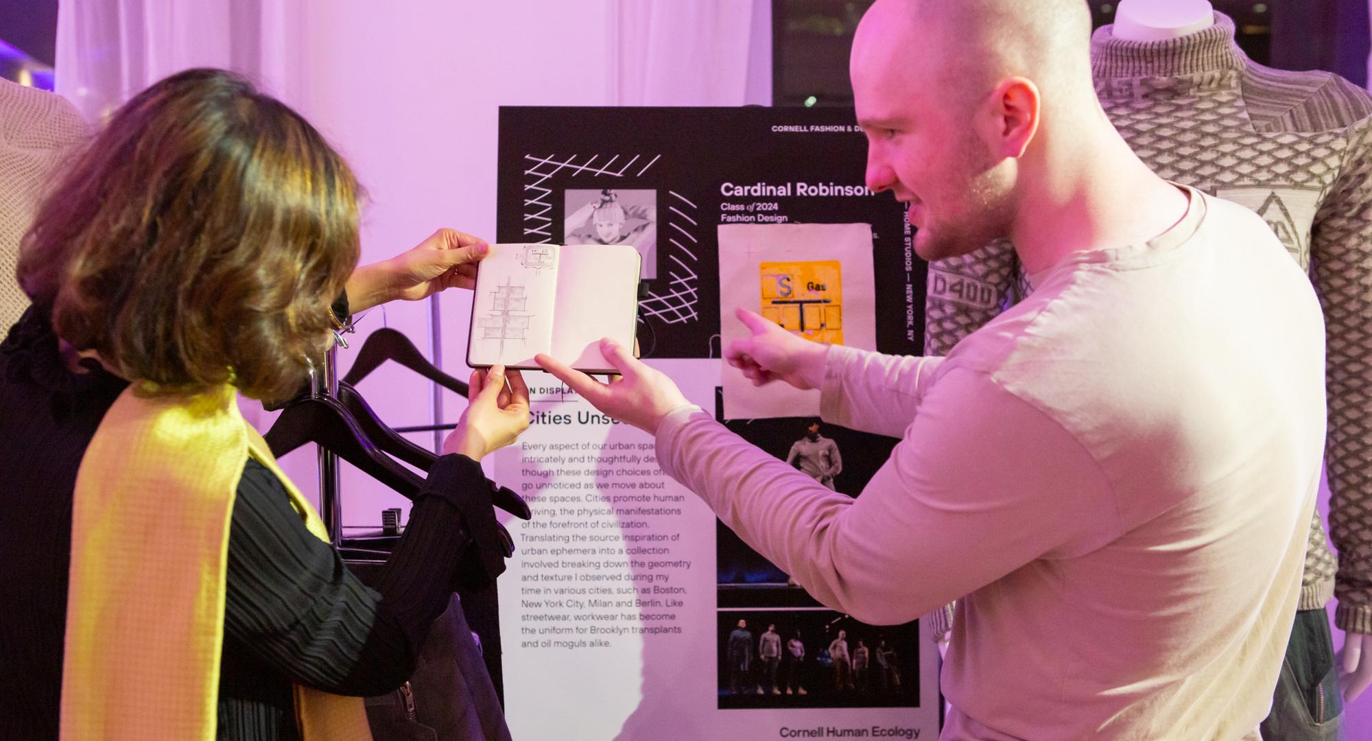 Student Cardinal Robinson shows an attendee the inspiration for his collection.