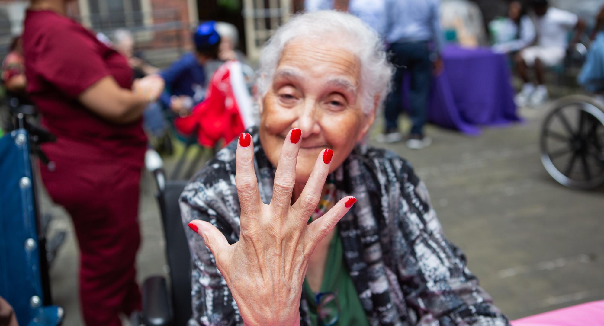 woman with red painted nails 