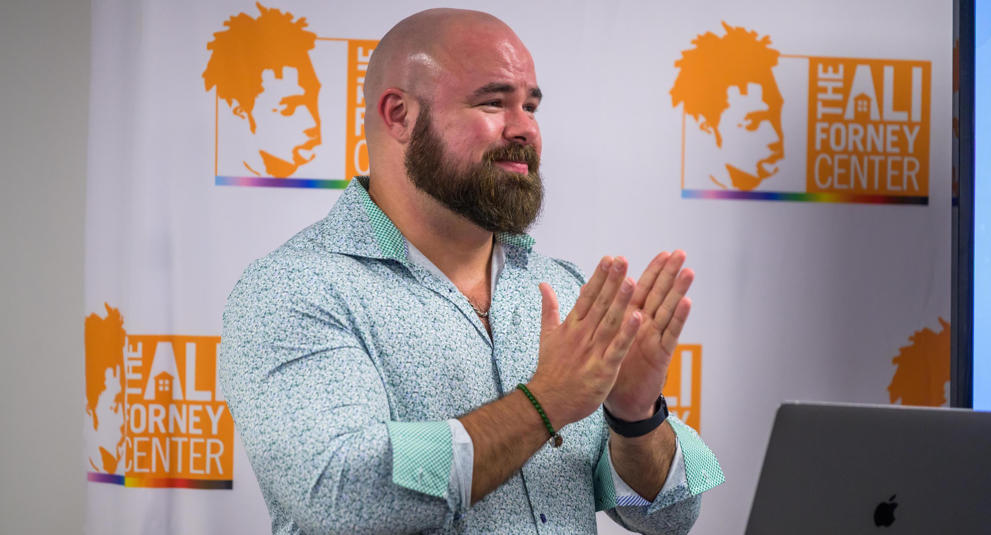 Adam Hoffman applauds during a presentation at The Ali Forney Center in New York City.