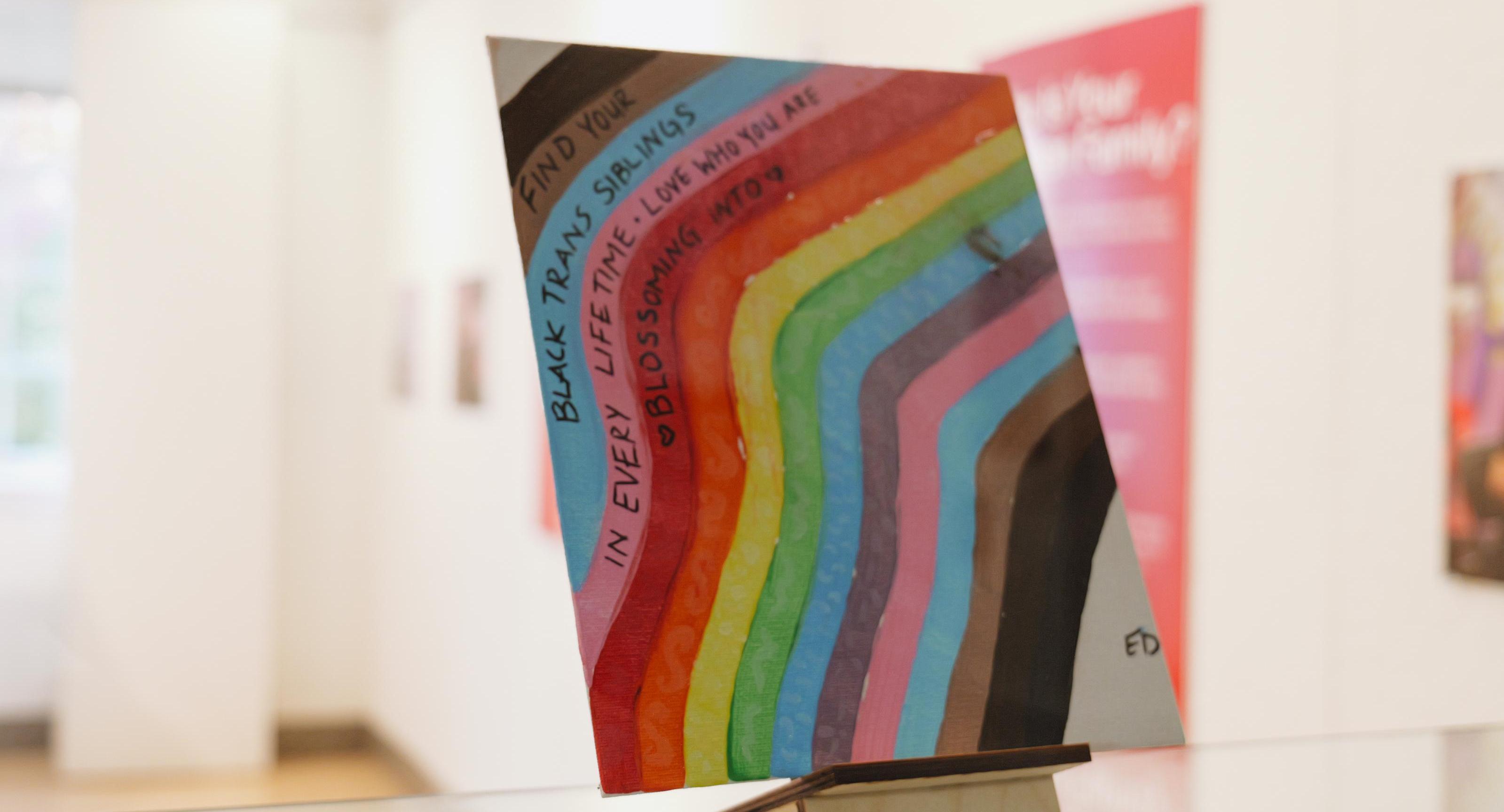 A multi-colored painting that encourages LGBTQ+ youth to find their chosen family.