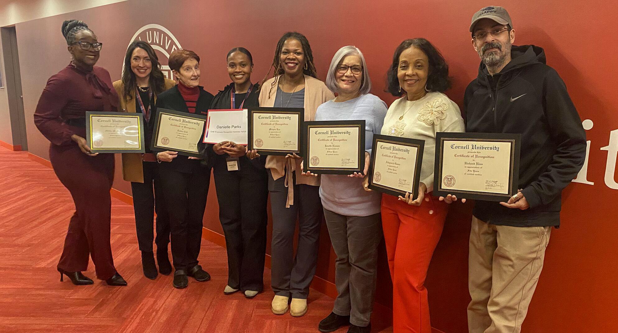 Staff members from CUCE-NYC with their awards at 570 Lexington Avenue.