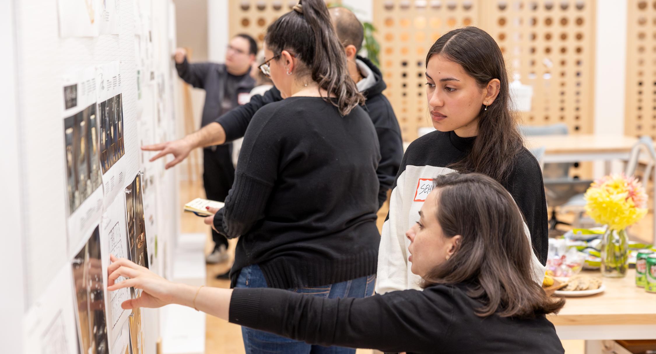Faculty member and student discuss a design project during a crit