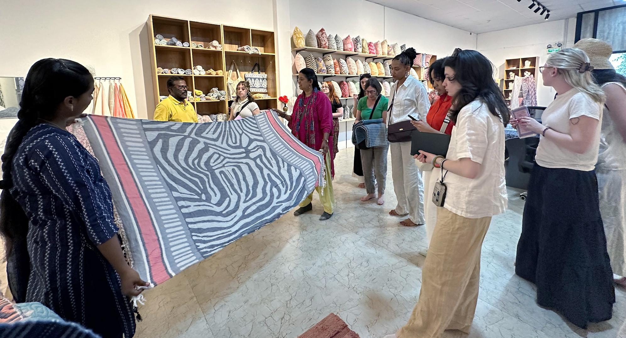 Students observe a woven garment 