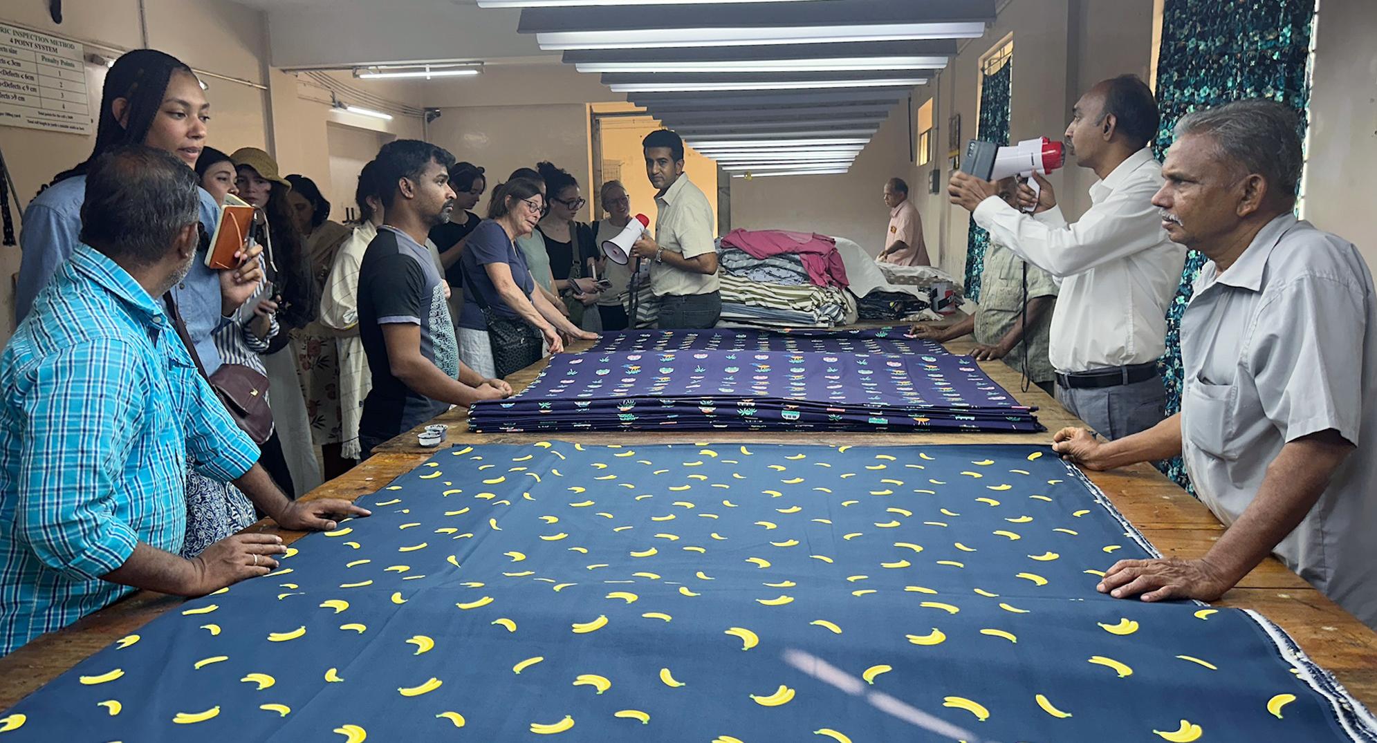 Students look at woven garments