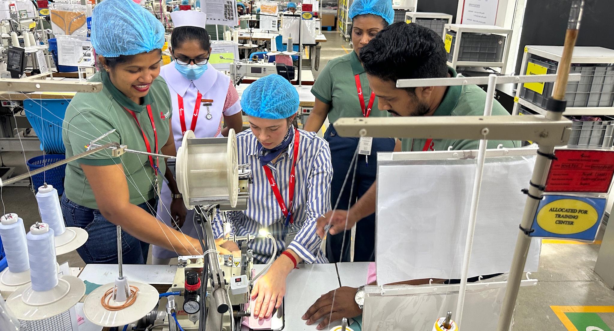 Sephra (center) sews a garment at a Brandix facility